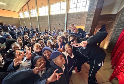 Ebumnandini team posing with learners inside a school hall