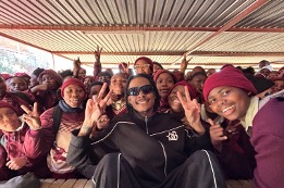 Students celebrating with Ebumnandini under the school shelter