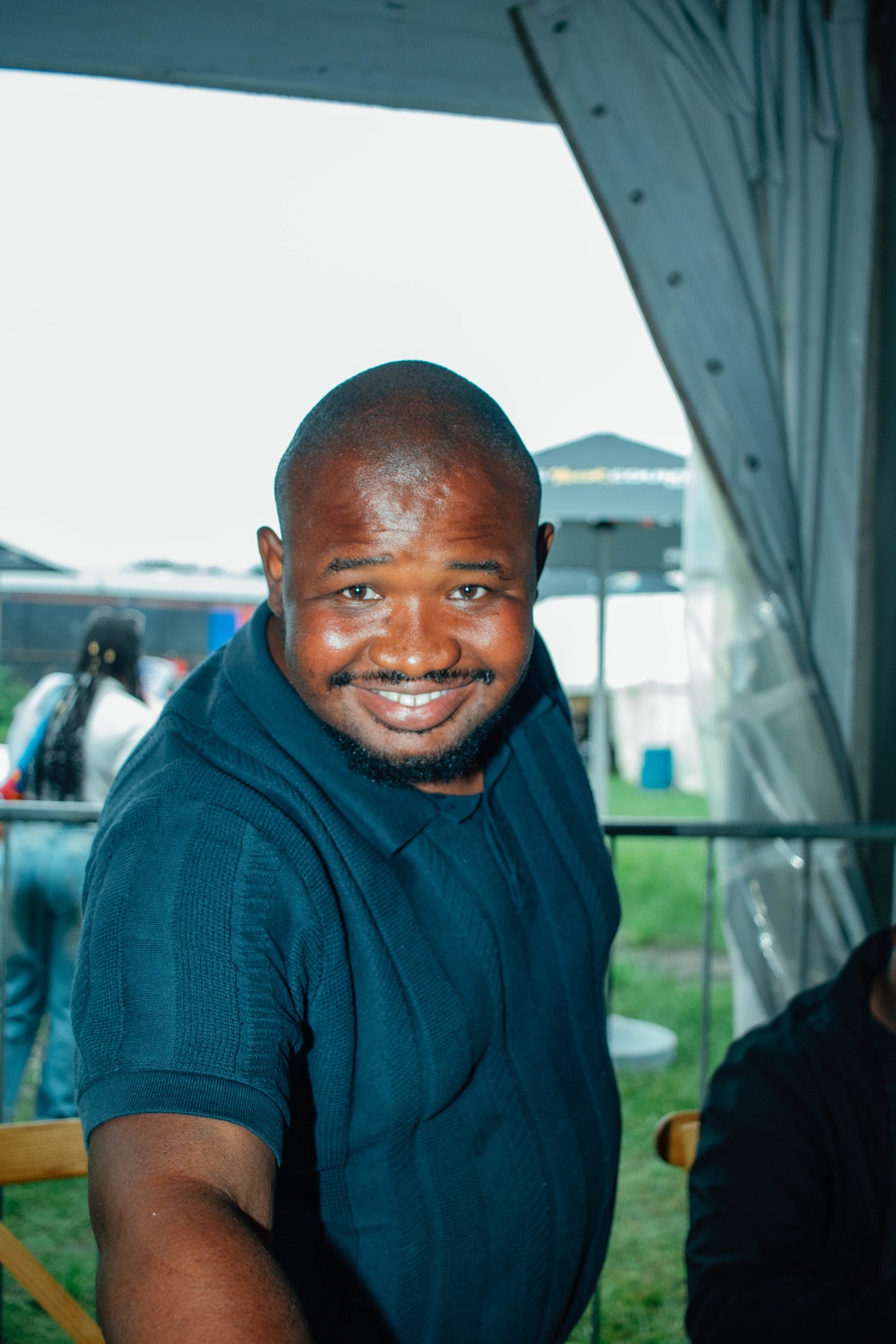 Portrait of a guest smiling under the tent canopy