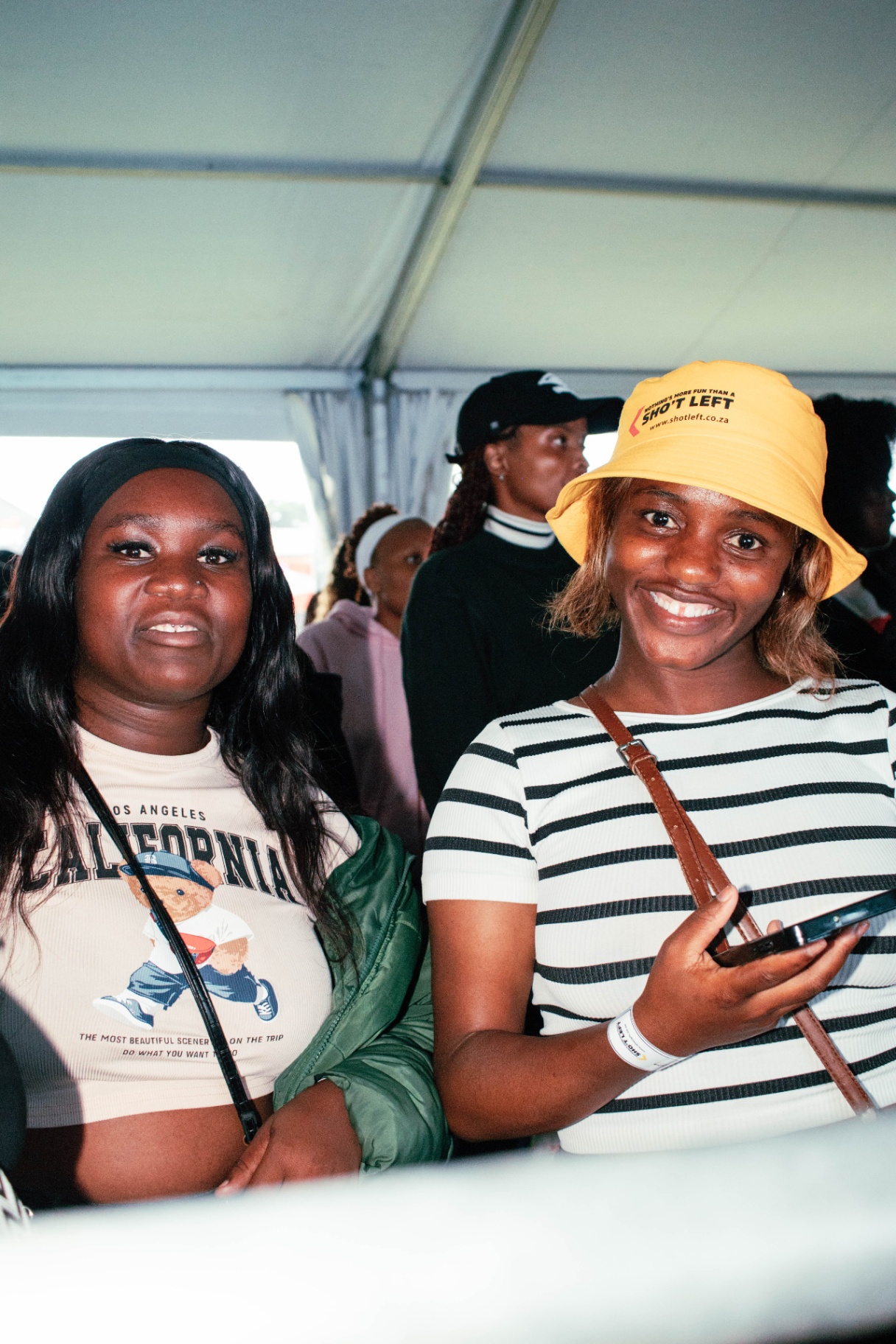 Two festival-goers smiling inside the tent