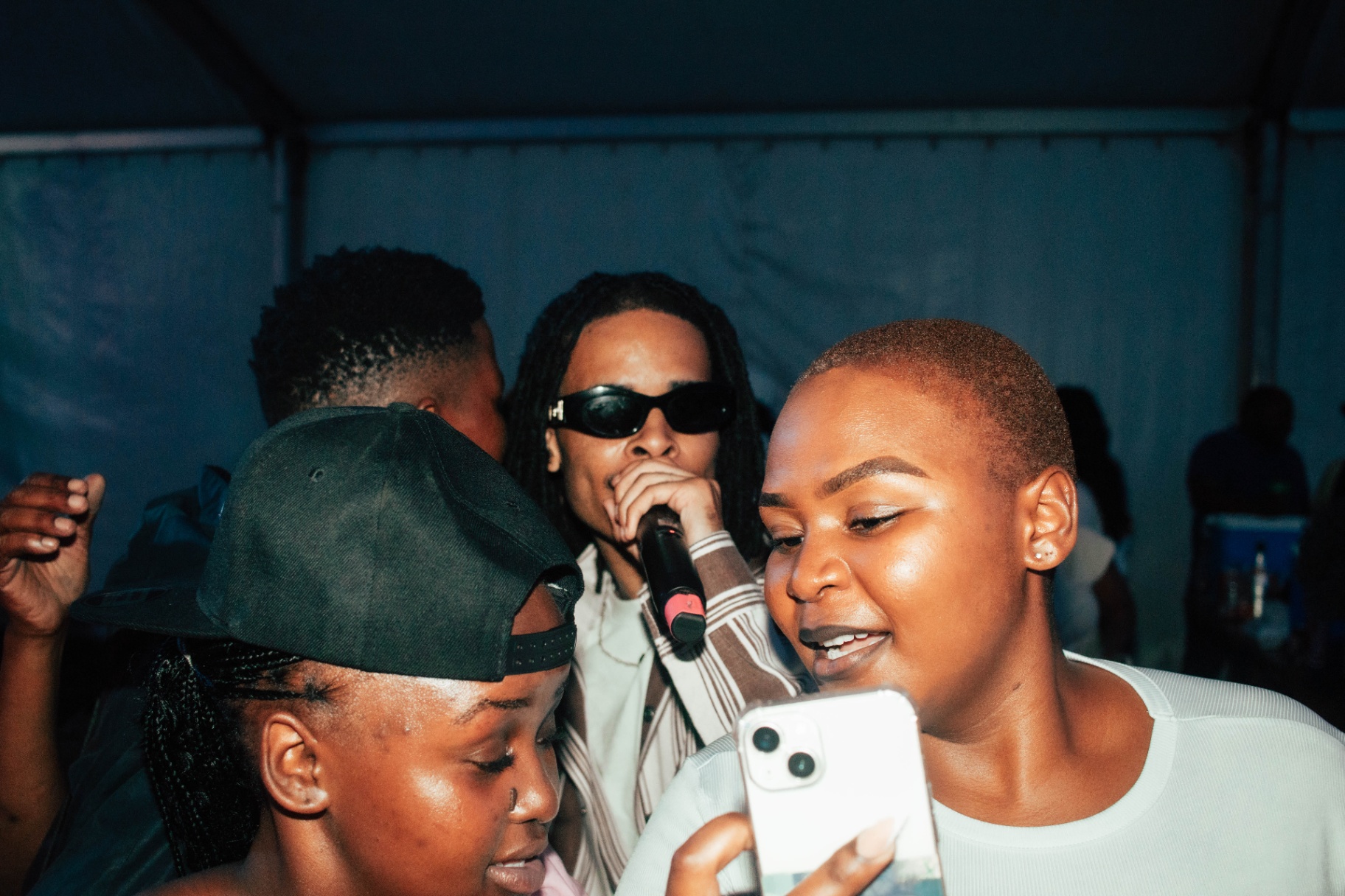 Artist performing with fans capturing the moment on phone