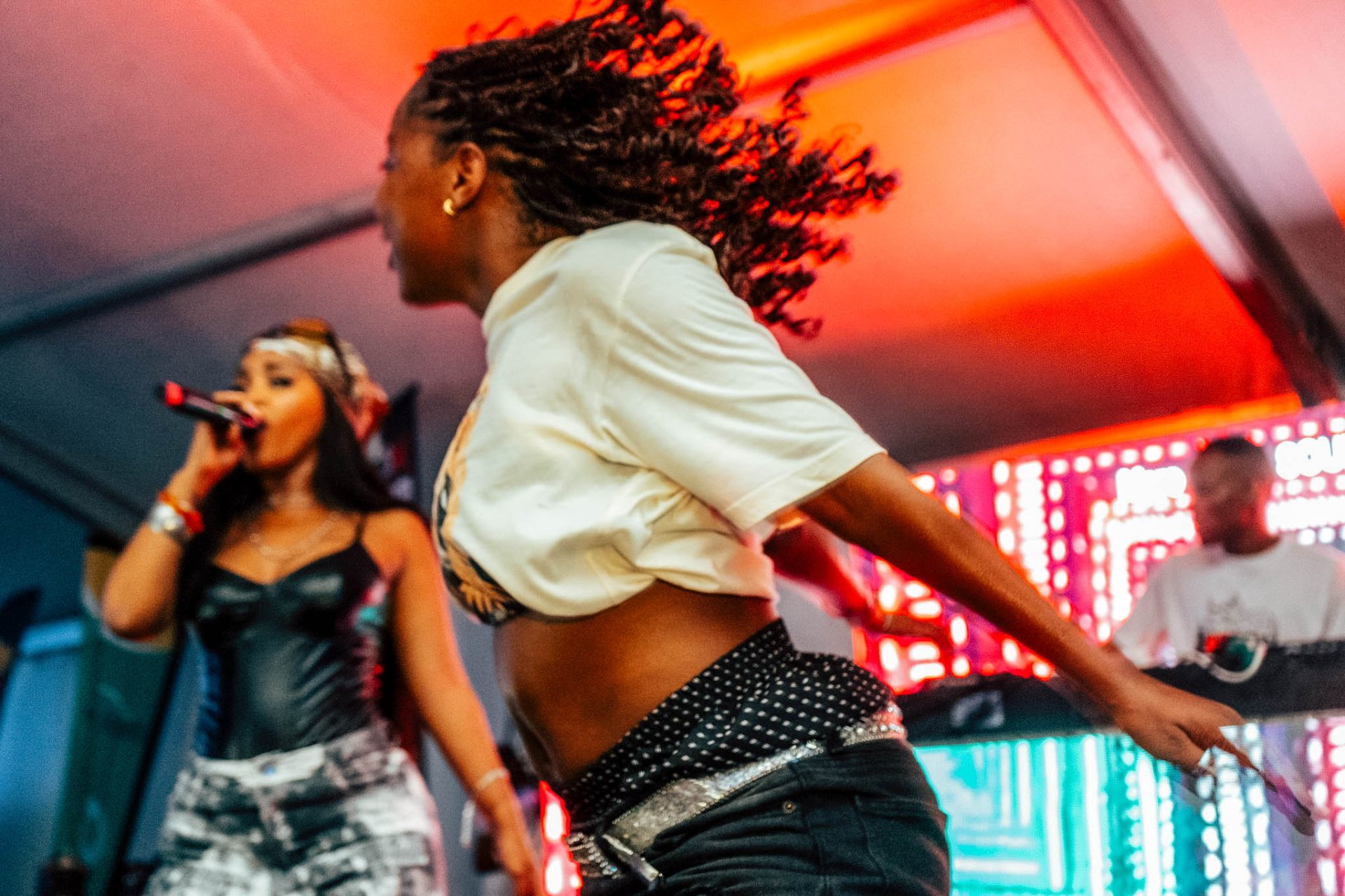 Dancer mid-spin with singer in background
