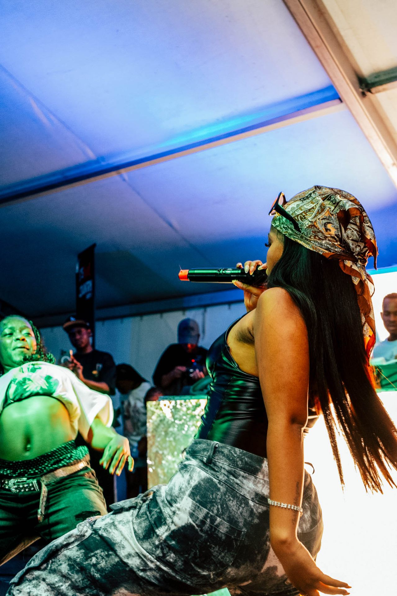 Performer and dancer under blue and green stage light